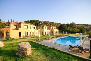 a resort with a swimming pool and some houses at Molivos Sunset Apartments in Mythimna