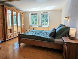 a bedroom with a bed with a dog sitting on it at Old Forge Modern Retreat 