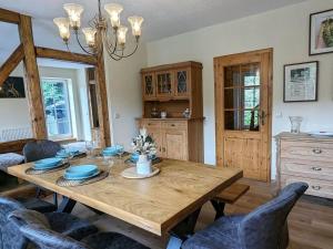 a dining room with a wooden table and chairs at Old Forge Modern Retreat 