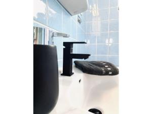 a bathroom with a sink and a faucet at Sea air Modern retreat in Wangerooge +19 photos