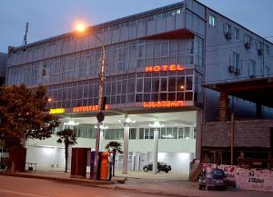 a hotel building with a street light in front of it at Hotel Okriba in Kutaisi