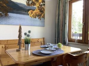 a wooden table with plates and dishes on it at Huis Hochfirst Appartement 20 in Titisee-Neustadt