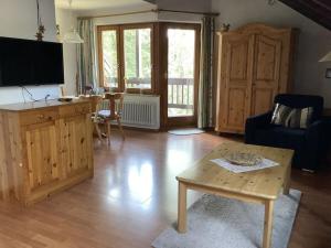 a living room with a table and a tv at Huis Hochfirst Appartement 20 in Titisee-Neustadt