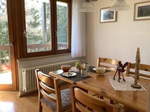 ein Esszimmer mit einem Holztisch und Stühlen in der Unterkunft Huis Hochfirst Appartement 9 in Titisee-Neustadt