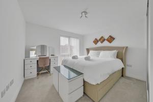 a white bedroom with a bed and a desk at 3 bedroom house in Bricket wood, St Alban in Garston