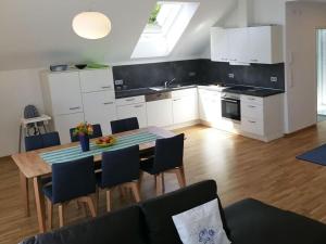 a kitchen and dining room with a table and chairs at Beech Modern Retreat in Hödingen