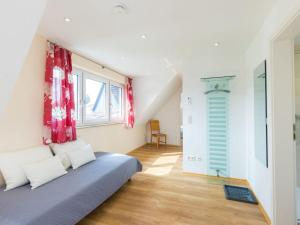 a bedroom with a bed with red curtains and a window at Oak Modern retreat in Überlingen in Überlingen