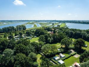 an aerial view of a park next to a lake at Deluxe Canal-Side Stay in Zevenhuizen