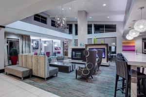a lobby with couches and a bar in a building at Residence Inn Jackson in Jackson