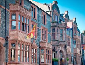 a large brick building with a kite in front of it at The Castle Hotel, Conwy, North Wales in Conwy