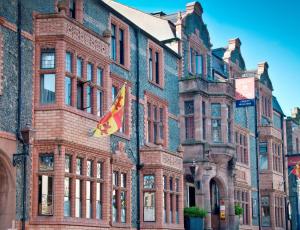 a large brick building with a kite in front of it at The Castle Hotel, Conwy, North Wales - The Coaching Inn Group in Conwy