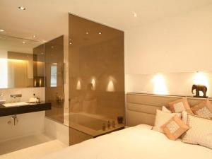 a bedroom with a shower and a bed with pillows at VISIONAPARTMENTS Gerechtigkeitsgasse - contactless check-in in Zürich