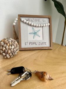 a table with a key chain and a sign on it at 2 BR Condo at Camella Manors Palawan in Puerto Princesa City