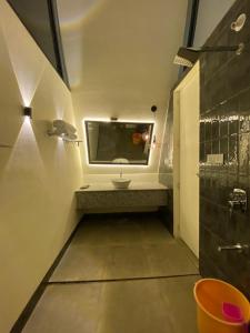 a bathroom with a sink and a mirror at NAMASTE BEACH RESORT in Jāmb