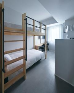 A bed or beds in a room at da Haus Shinjuku