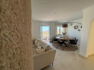 a living room with a couch and a table at Casa Vista Bonita in Pedreguer