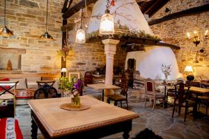 a dining room with tables and chairs and a brick wall at Via Avis in Santa Catalina de Somoza