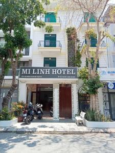 a hotel with motorcycles parked in front of it at Mi Linh Hotel in Nha Trang