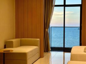 a room with a chair and a window with a view at The Shore by MD Staycation in Kota Kinabalu