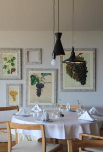 a dining room with a white table and chairs at Vale d'Azenha Hotel Rural & Residences in Alcobaça