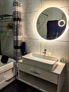 a bathroom with a sink and a mirror at Kavi's Vacation Homes - Sainj in Sainj