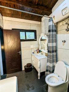 a small bathroom with a toilet and a sink at Kavi's Vacation Homes - Sainj in Sainj
