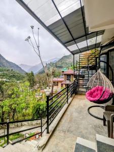 a balcony with a view of the mountains at Kavi's Vacation Homes - Peaceful stay in sainj valley in Sainj