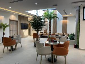 a lobby with a waiting room with tables and chairs at فيرانو - Virano in Riyadh