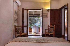 a bedroom with a bed and a table and chairs at Villa Federica: Natura e Mare in Torre delle Stelle