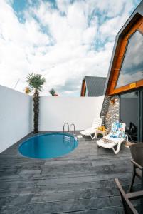 a patio with a swimming pool on top of a house at SAPANCA KIYI BUNGALOV&CAFE in Sakarya