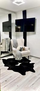 a living room with a white couch and a black rug at Spa luxury app for 2 or 4 pers centre lac view in Montreux