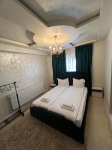 a bedroom with a large bed with two towels on it at pensiunea medellin in Tulcea