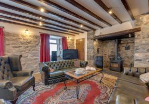 a living room with a couch and a fireplace at Cyfannedd Uchaf in Fairbourne