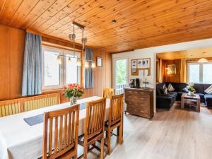 a dining room and living room with a table and chairs at Holiday home in the Silvretta-Montafon ski area in Sankt Gallenkirch