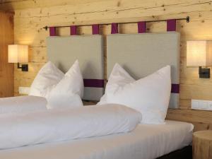 a bedroom with two beds with white pillows at Great chalet in an idyllic location in Wagrain in Wagrain