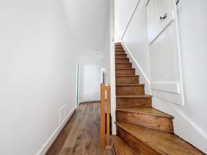 a hallway with a wooden staircase in a house at La Bicoque de Saint Gerand in Saint-Gérand-le-Puy