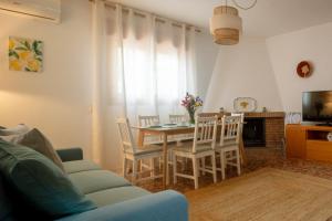 a living room with a dining room table and chairs at Casa El Limonero in Níjar +33 photos