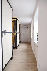 a hallway with white doors and a wooden floor at Schöndorf Hostel - virtual reception in Bratislava