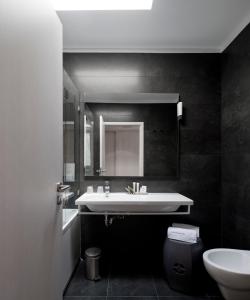 a bathroom with a sink and a toilet at Furadouro Boutique Hotel Beach & SPA in Ovar +35 photos