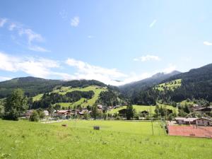 a green field with a tennis court on a hill at Appealing Apartment in Kleinarl with Ski Storage in Kleinarl
