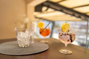 a table with three glasses of drinks on it at Hotel Narenta in Metković
