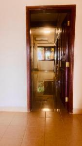 a hallway with an open door to a room at Va’s home in Kilifi