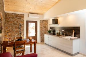 a kitchen with a table and a counter top at Casa Feraxi at Casa Sardinia in Muravera +12 photos