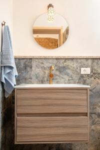 a bathroom with a sink and a mirror at Casa Feraxi at Casa Sardinia in Muravera