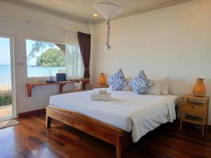 1 dormitorio con 1 cama grande y ventana grande en Twin Bay Resort - SHA Extra Plus, en Ko Lanta