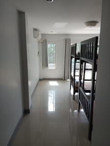 a hallway of a house with stairs and a room at ISI Backpackers' in Mae Sot