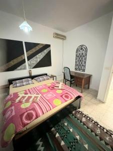 a bedroom with a bed and a desk and a chair at Anis 2 in Sousse