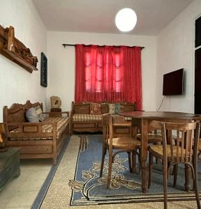 a living room with a table and a couch at Anis 2 in Sousse