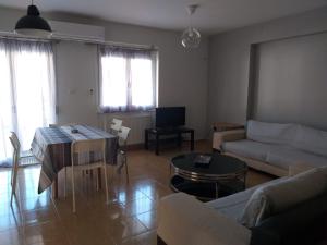 a living room with a couch and a table at dimis apartment in Nea Michaniona