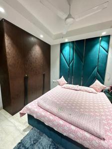a bedroom with a large bed with a large headboard at The LUTF in New Delhi